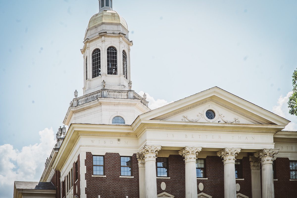 A large building in Waco, Texas, with a clock on top of it.