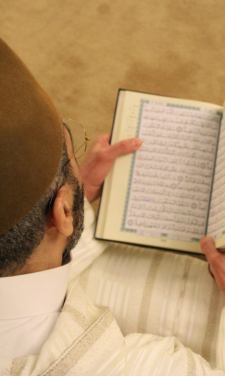 man reading the Qur’an