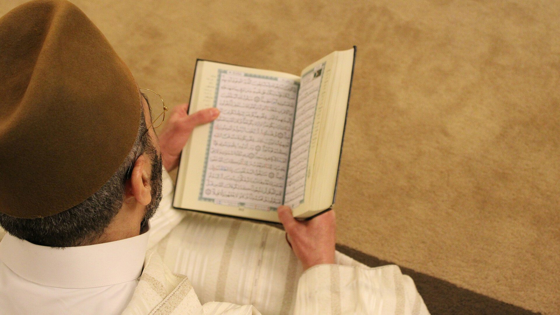 man reading the Qur’an