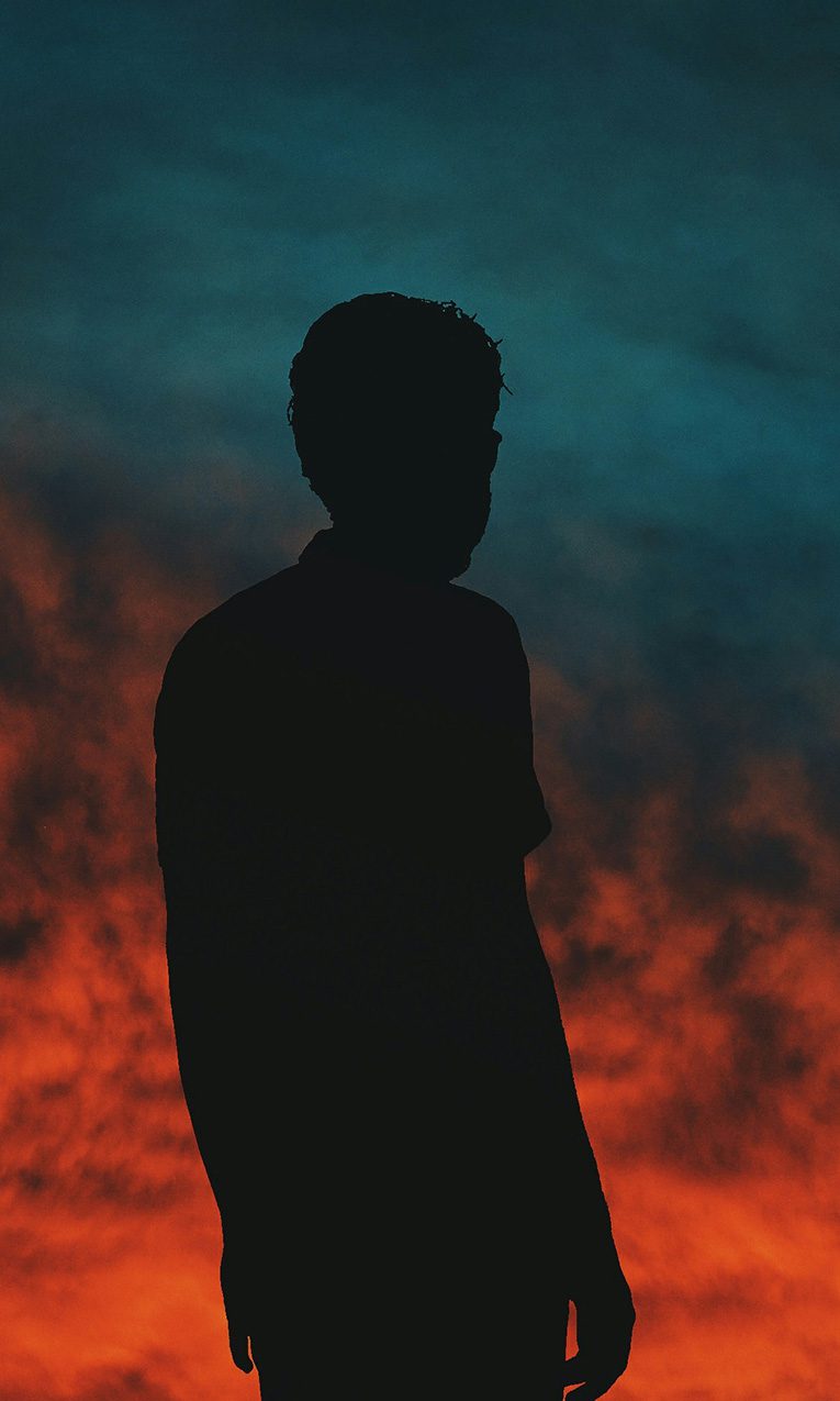 young man looking at the sunset
