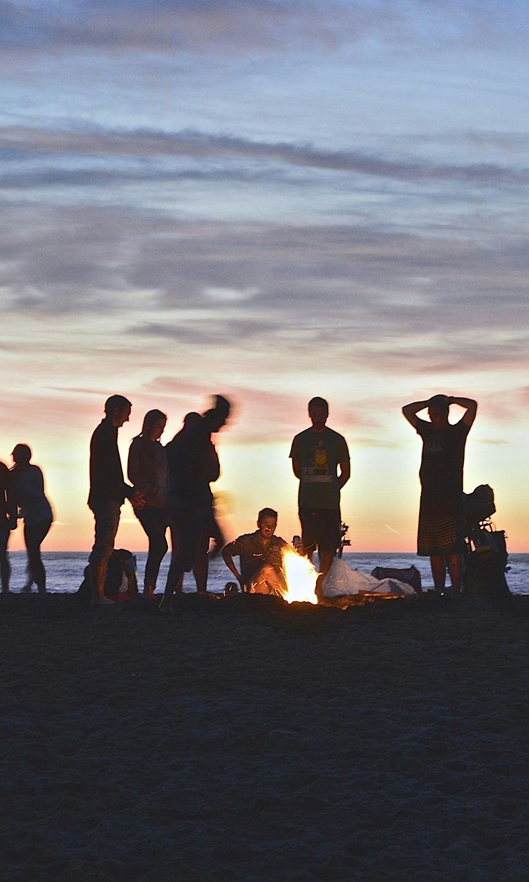 college students sitting around a bonfire