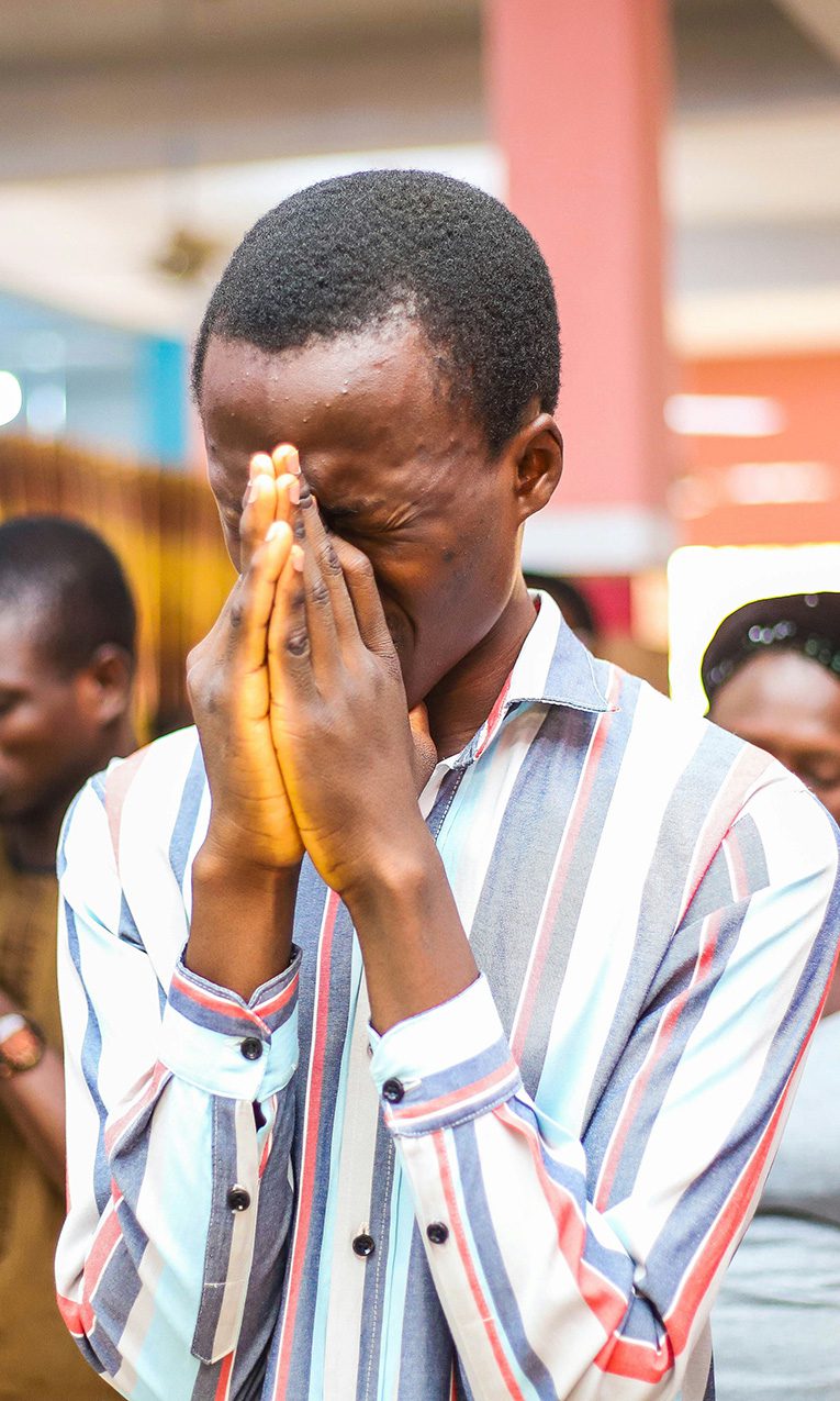 a man praying during church worship service