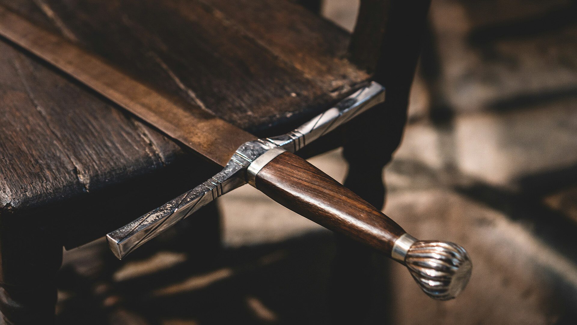 sword on a brown wooden table