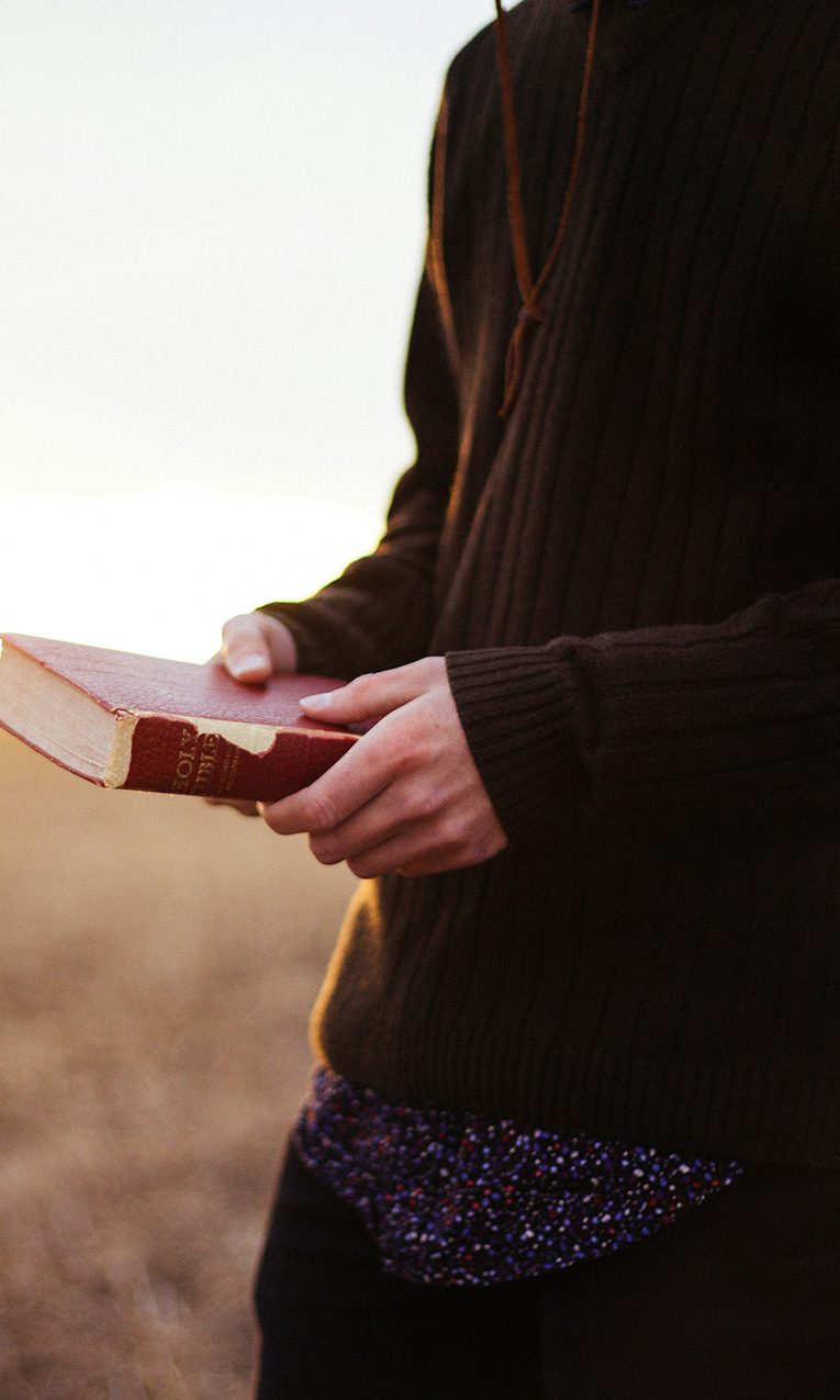 a man holding a Bible