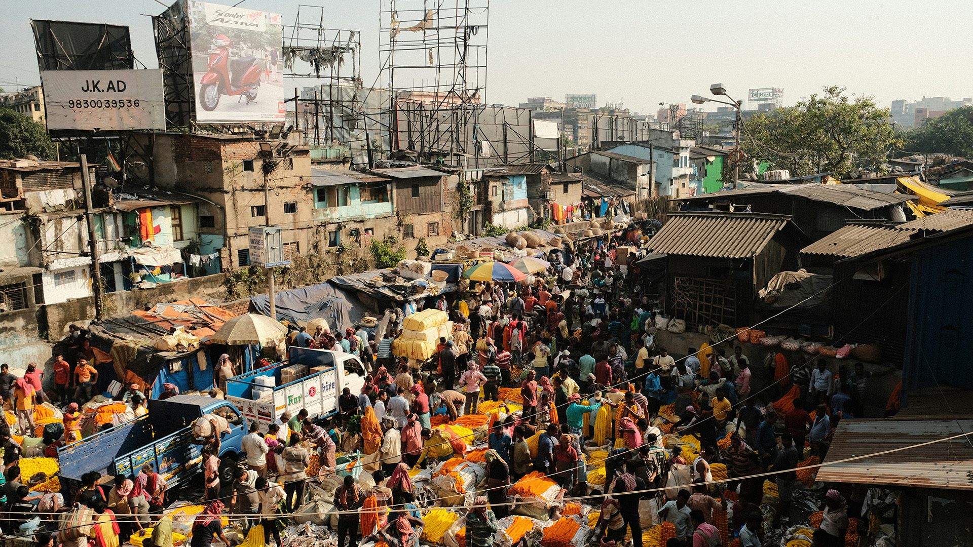 a large crowd of people in the Kolkata Flower Market in India