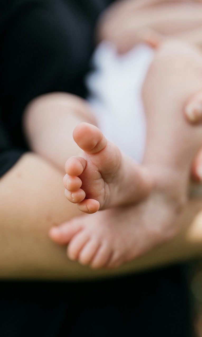 a woman carrying a newborn child
