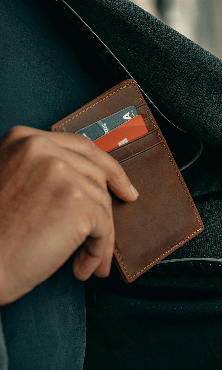 a man holding a wallet in his pocket