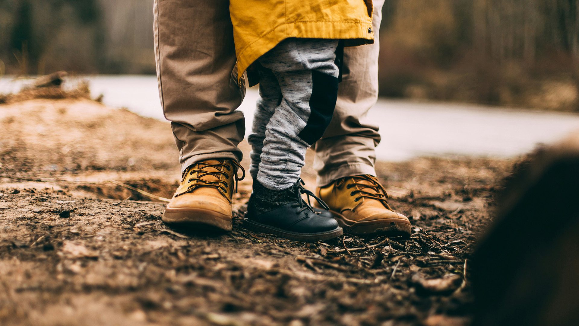a child standing next to his dad