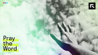 A hand lifted in prayer.