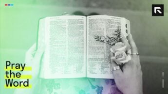 A woman holding an open Bible.