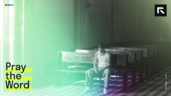 A man sitting on a church pew.