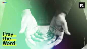 A man with hands held out in prayer.