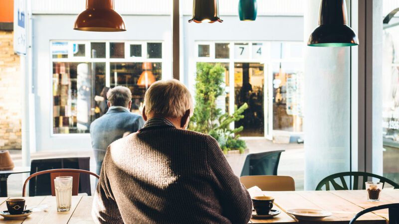A man sitting by himself at a café.