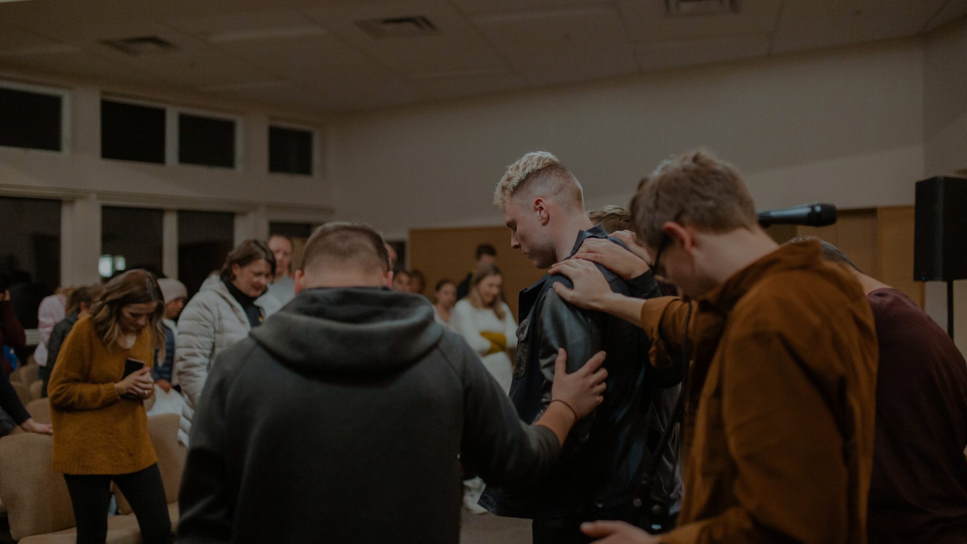 A group of men praying at a local church.