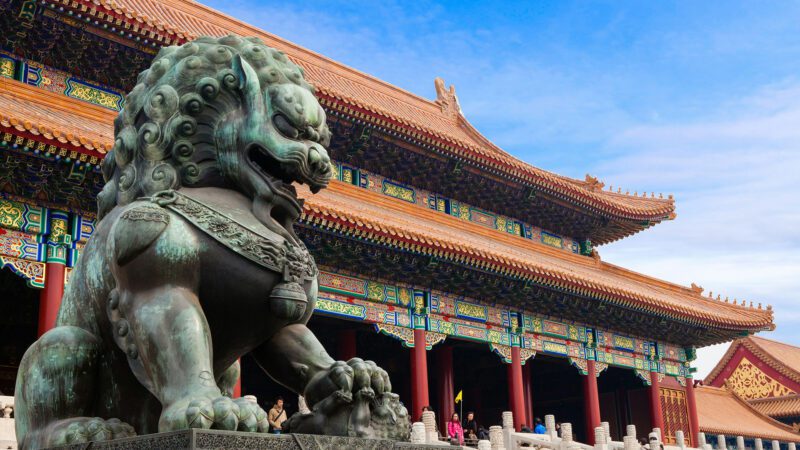 Gray concrete statue of a lion at The Hall of Supreme Harmony within the Forbidden City in Beijing, China.