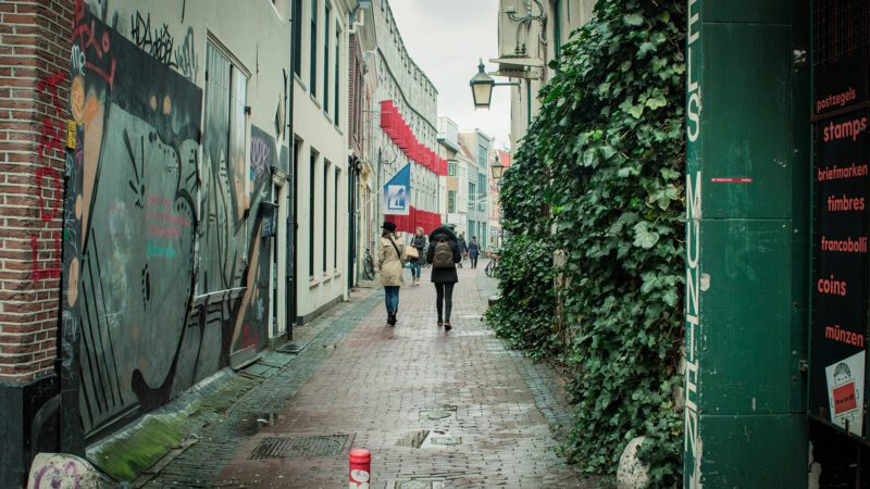 Two friends walking in the street.