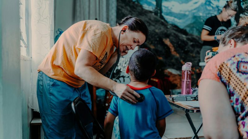 A missionary doctor evaluating a boy.