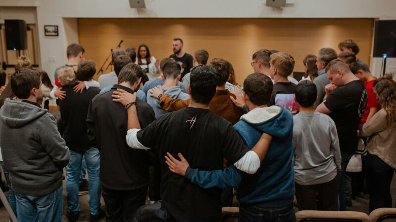 A group of people praying at church.
