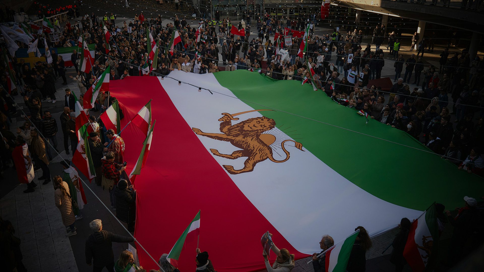 The Iranian flag held by a multitude of people.