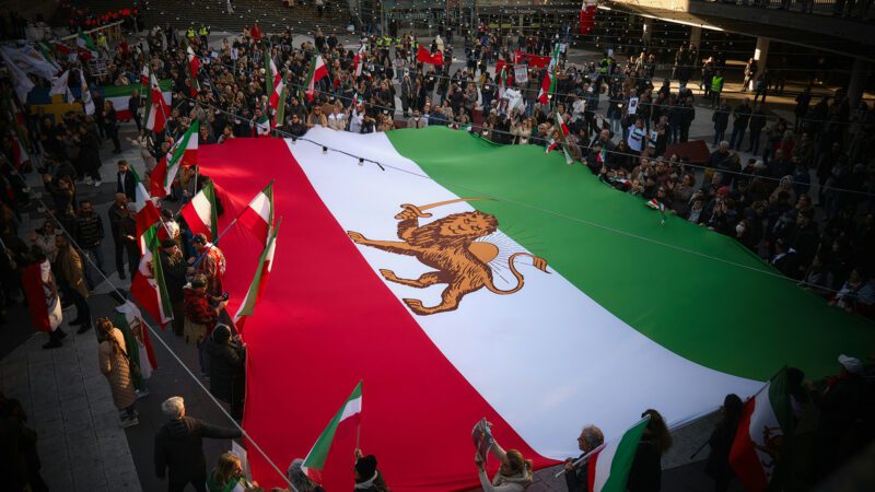 The Iranian flag held by a multitude of people.