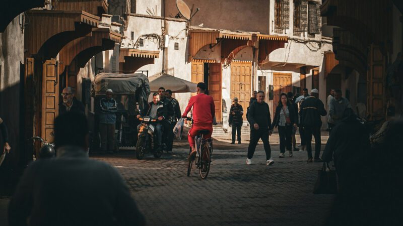 A cyclist moves through a busy street.