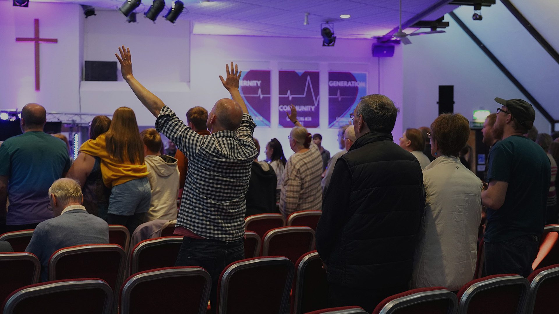 Congregation of people worshipping in a church.