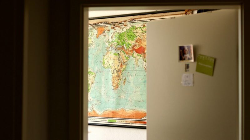 An open door showing a map inside a room.