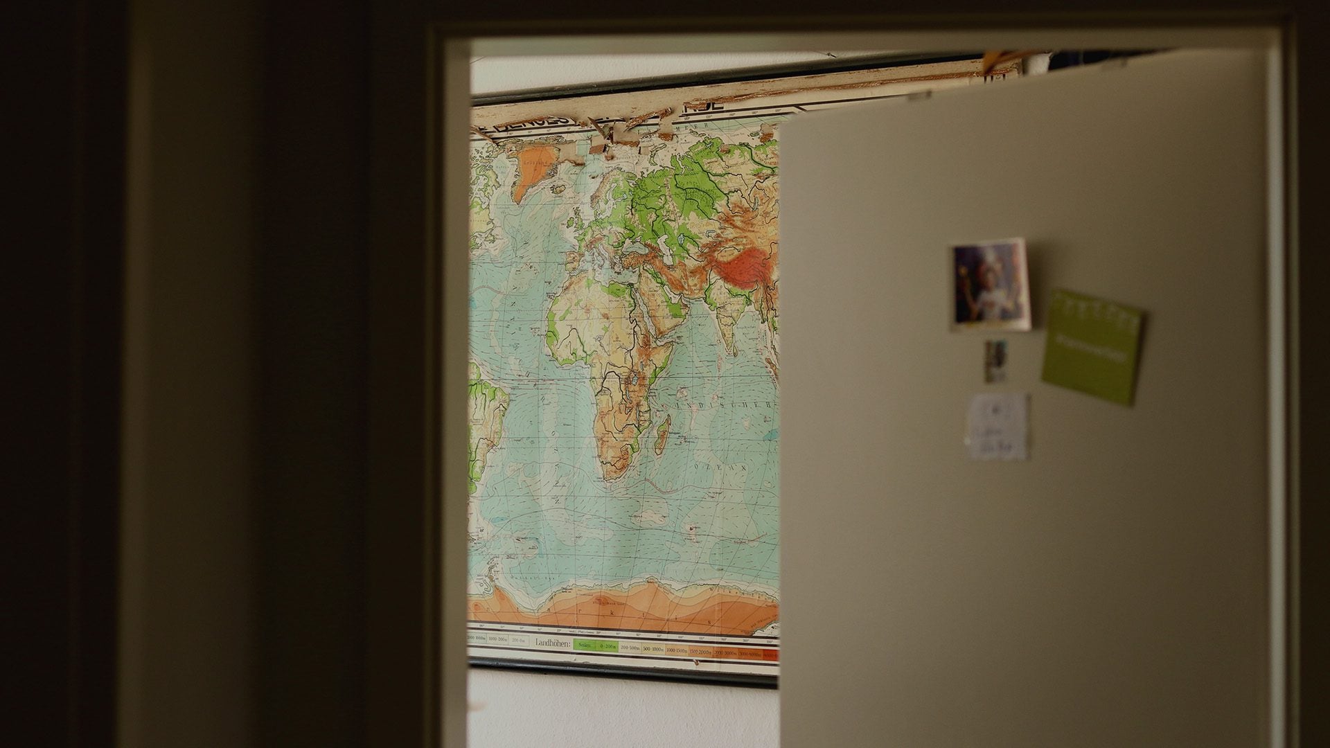 An open door showing a map inside a room.