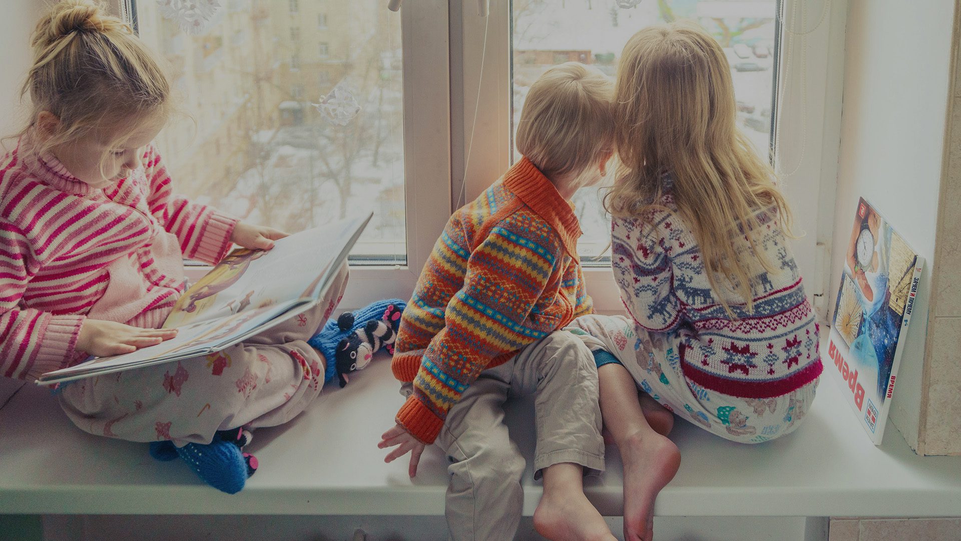 Children looking out a window.