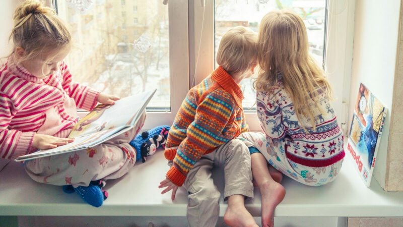 Children looking out a window.